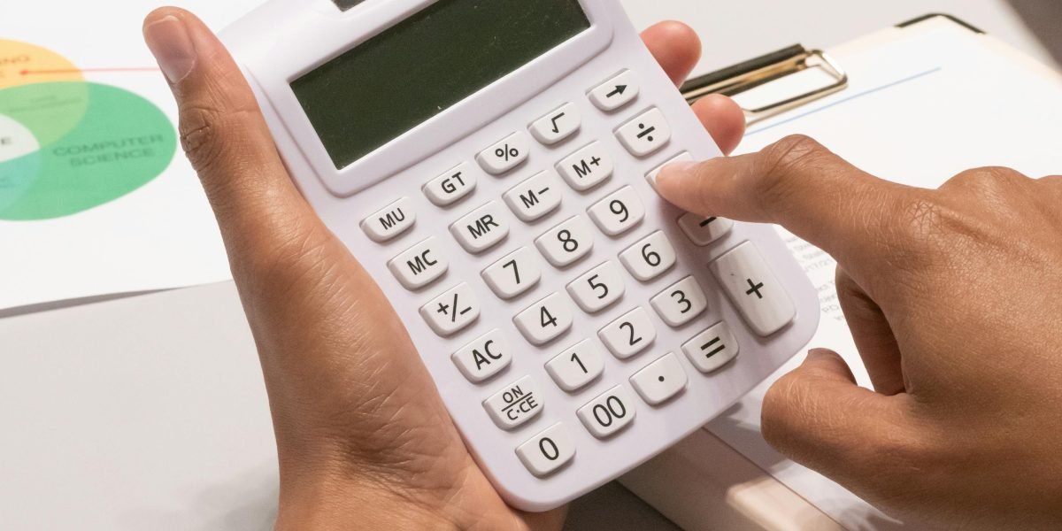 A person thoughtfully operating an online tool on a desktop, illustrating the practical use of the RERA Rental Index Calculator.