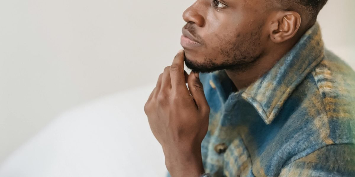 A person contemplating different options, symbolizing the decision-making process for rental locations beyond Dubai.