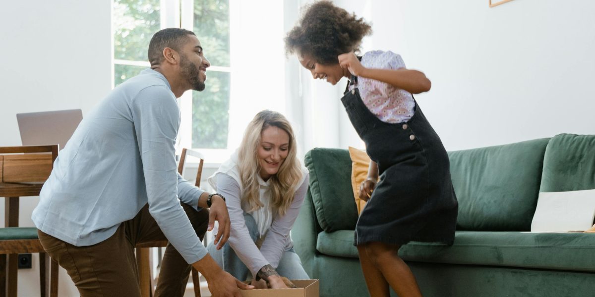 A family relaxing in a bright, spacious living room, representing the value of larger properties in Abu Dhabi.