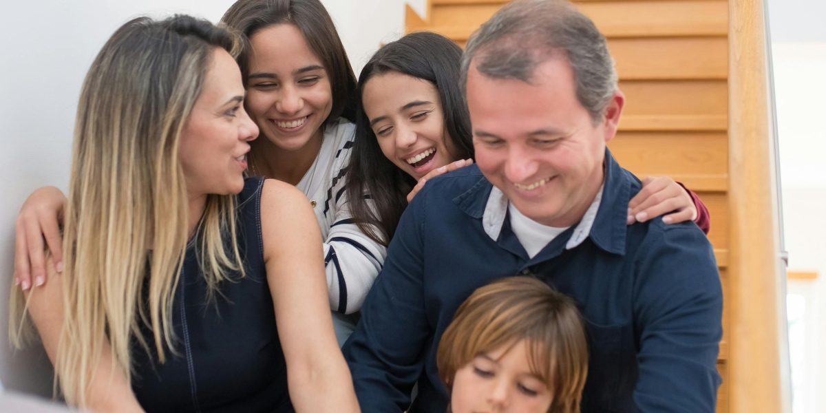 A family sits together, discussing their options for a new home and lifestyle.