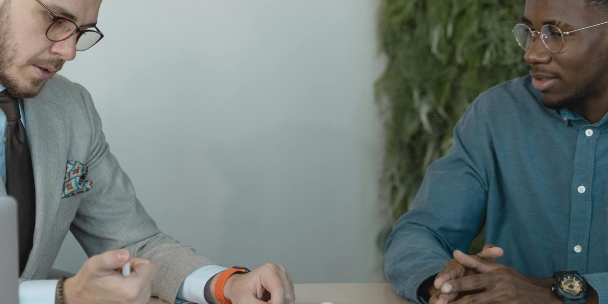 Two professionals engaged in an interview, representing the importance of thoroughly vetting an agent.