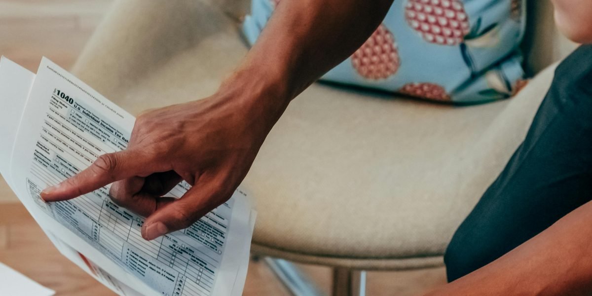 A person diligently reviewing legal or financial documents related to a property purchase.