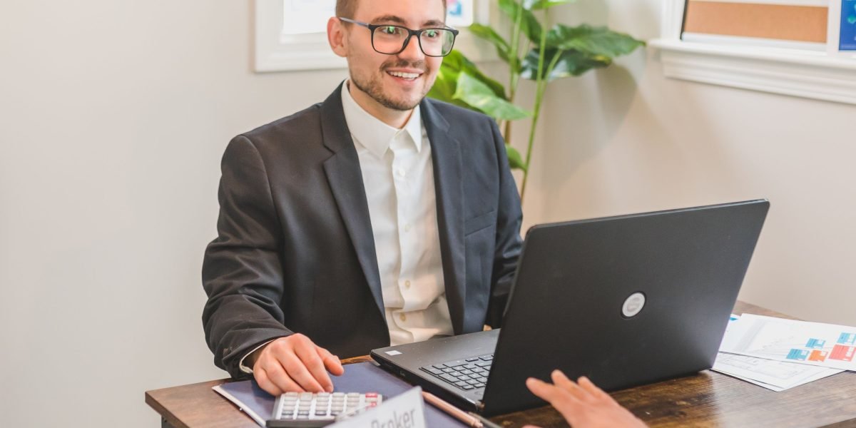 An investor discusses potential risks and returns of an off-plan property with a trusted real estate consultant.