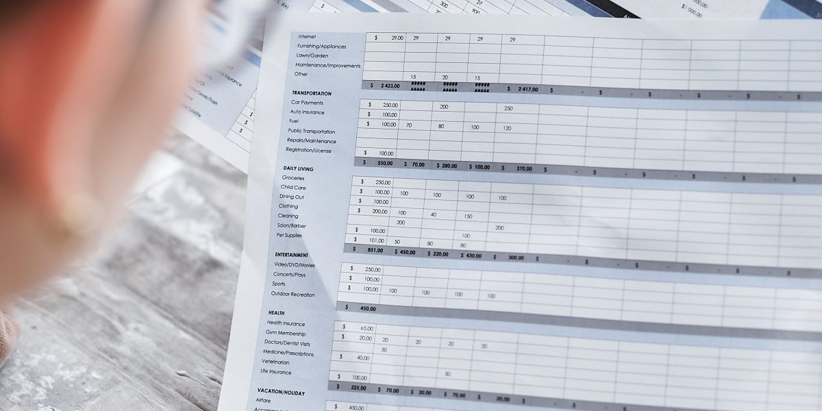 An individual carefully examining financial statements, representing the detailed analysis of investment risks and returns.