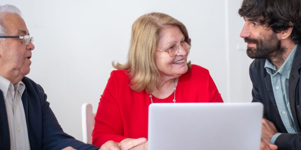 People engaged in a discussion with a financial advisor about mortgage options and investment strategies for property purchase.