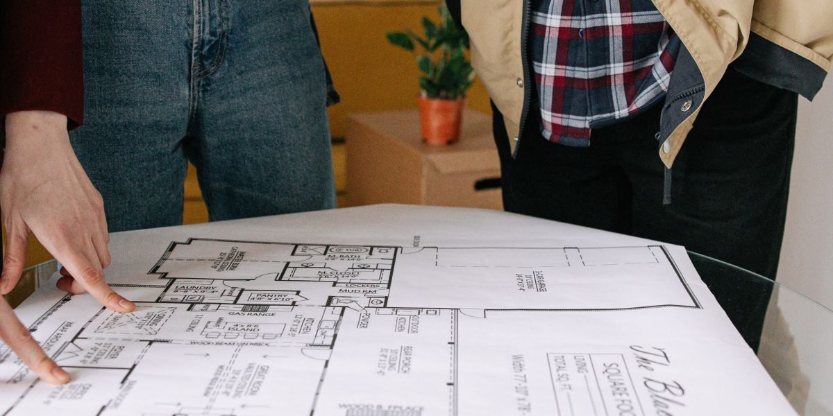 A couple reviewing a map to pinpoint ideal luxury living neighborhoods in Dubai.