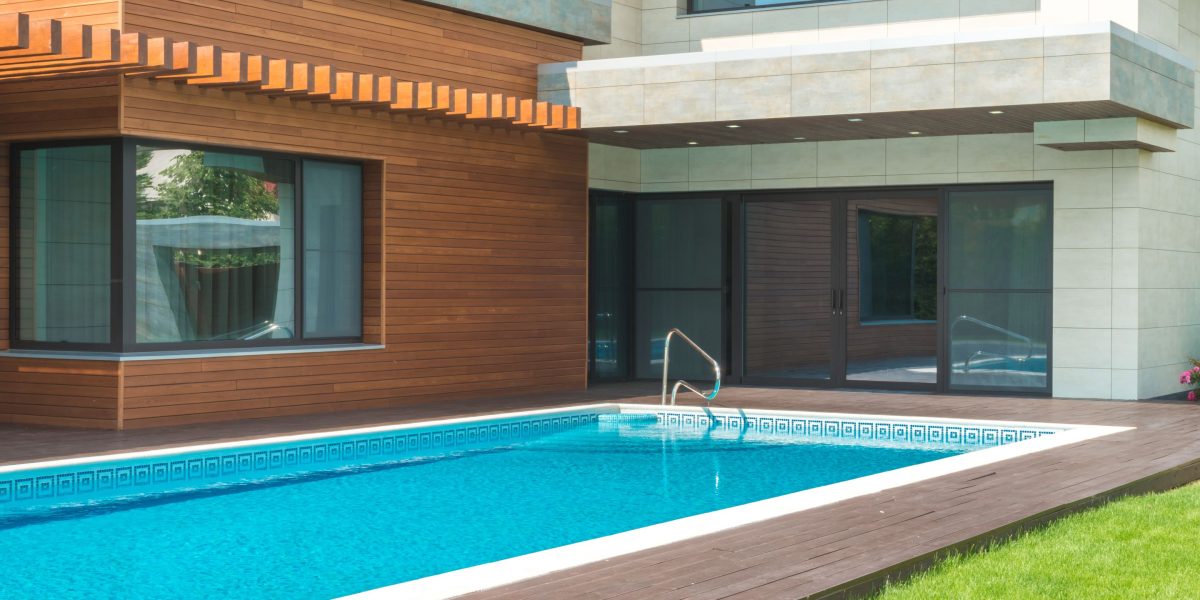A family enjoying their private pool with the iconic Dubai skyline in the background.