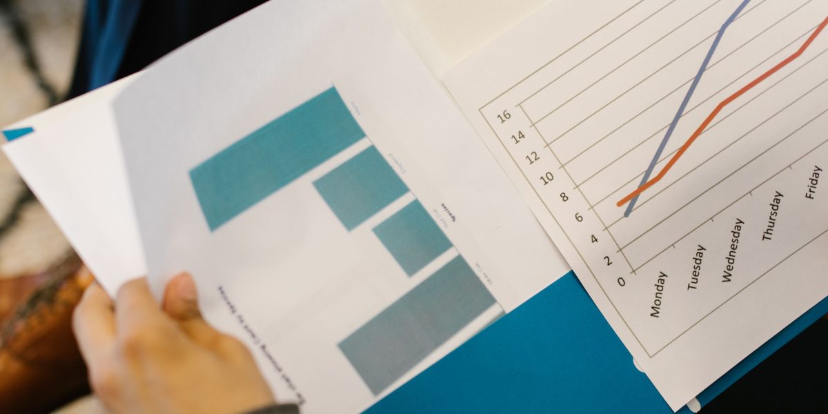 A person looking satisfied while reviewing investment returns on a document.
