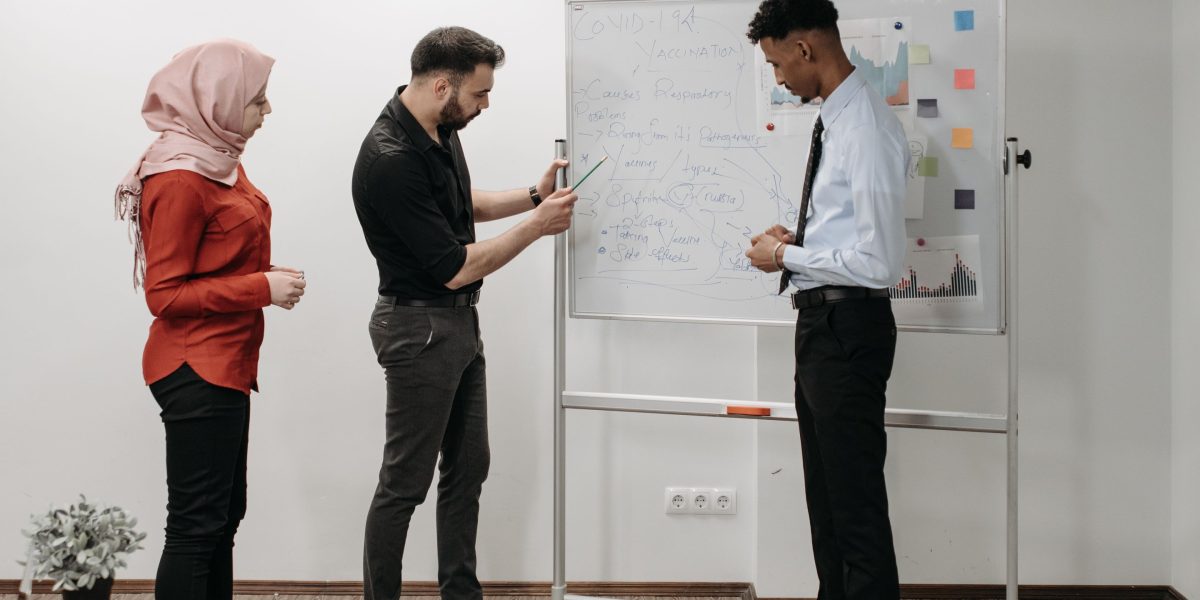 A group of professionals collaborating and discussing strategy, representing a strong, productive partnership.