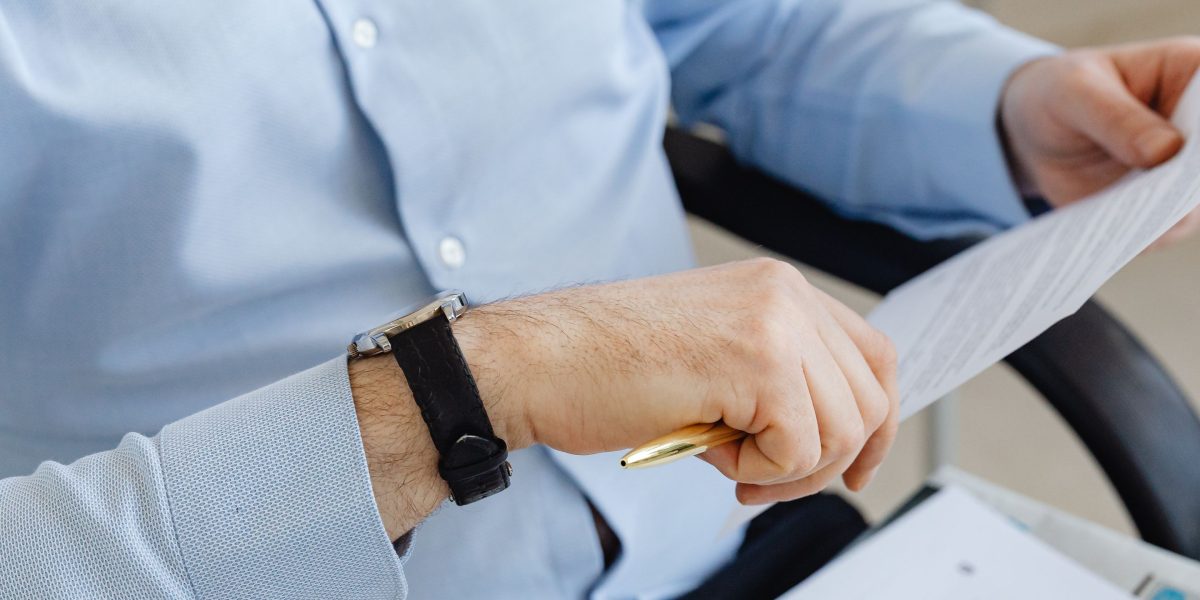 A prospective buyer meticulously examining legal and financial documents during the due diligence process.