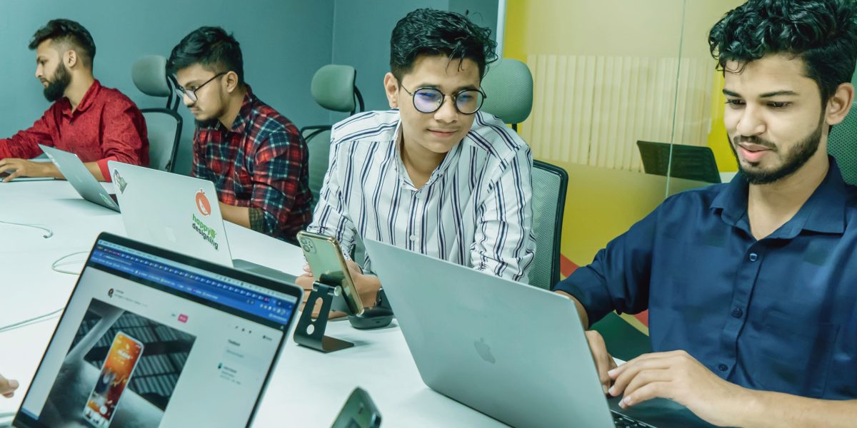 Young professionals collaborating in a modern office or co-working space, reflecting Business Bay's appeal.