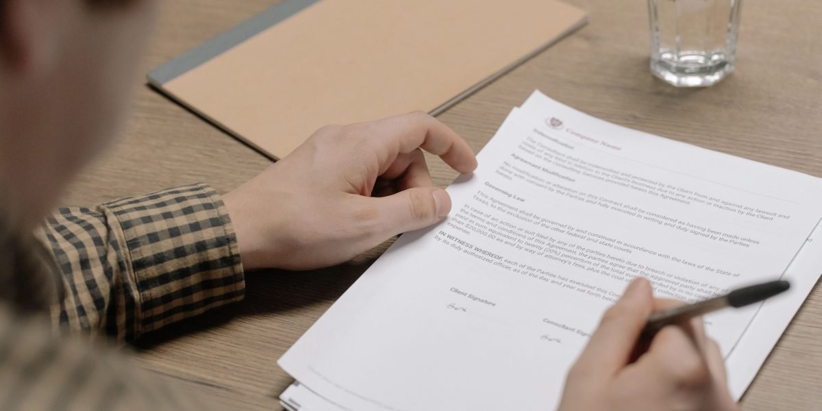 A professional person reviewing a legal contract, emphasizing the importance of understanding terms.