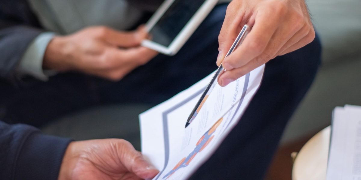 A client consults with a real estate lawyer to ensure all legal aspects of a property purchase are covered.