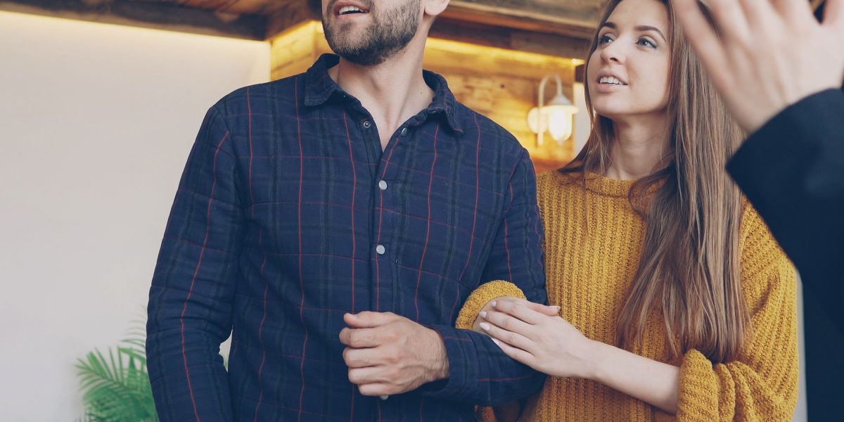 A person thoughtfully considering various property investment options, reflecting the initial search phase in a complex market.