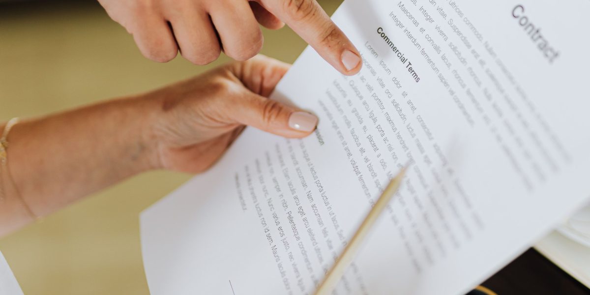 Professionals engaged in a discussion over rental contract documents, highlighting the importance of clear agreements.