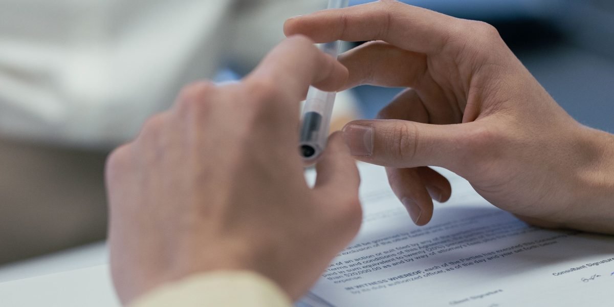 The final stage of property acquisition, marked by signing contracts and a professional handshake.